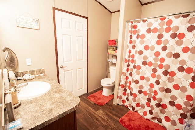 bathroom with vanity, a shower with shower curtain, wood finished floors, ornamental molding, and toilet
