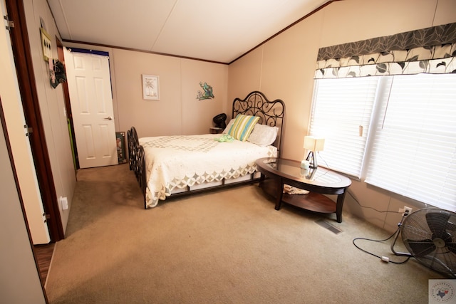 bedroom with carpet flooring, visible vents, and ornamental molding