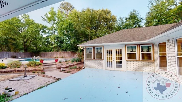 view of patio featuring a fenced in pool and french doors