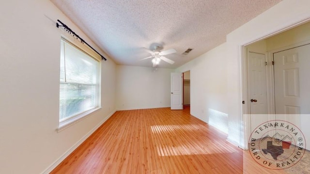 unfurnished room with hardwood / wood-style flooring, a textured ceiling, and ceiling fan