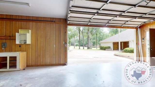 garage featuring wood walls