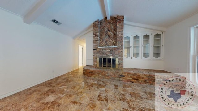 unfurnished living room featuring lofted ceiling with beams and a brick fireplace