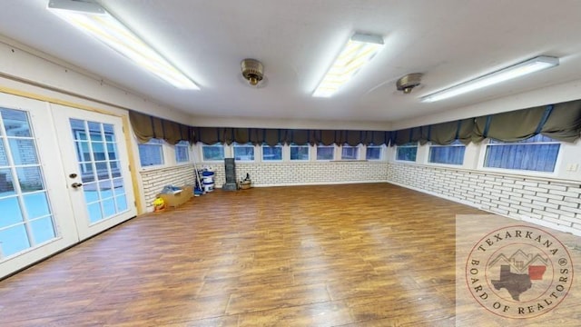 exercise room with brick wall and french doors