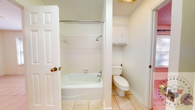 bathroom with toilet, a textured ceiling, and tile patterned flooring