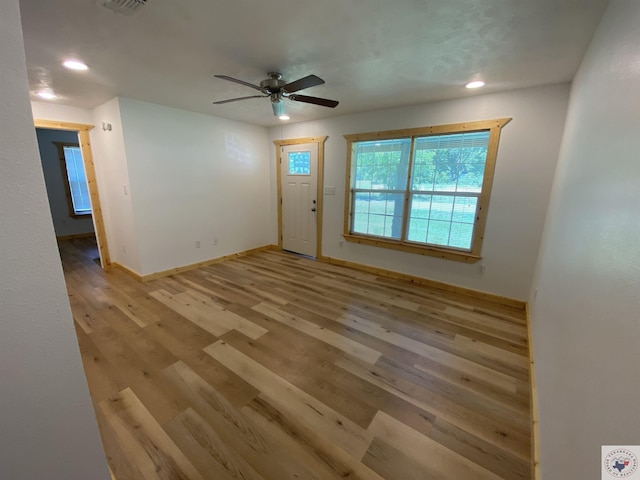 interior space with light hardwood / wood-style floors and ceiling fan