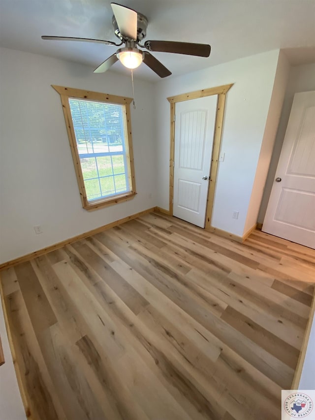 unfurnished bedroom with light hardwood / wood-style floors and ceiling fan