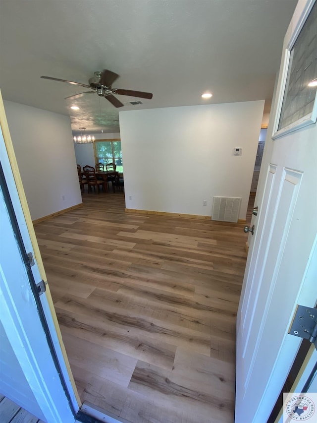 unfurnished room featuring ceiling fan and wood-type flooring