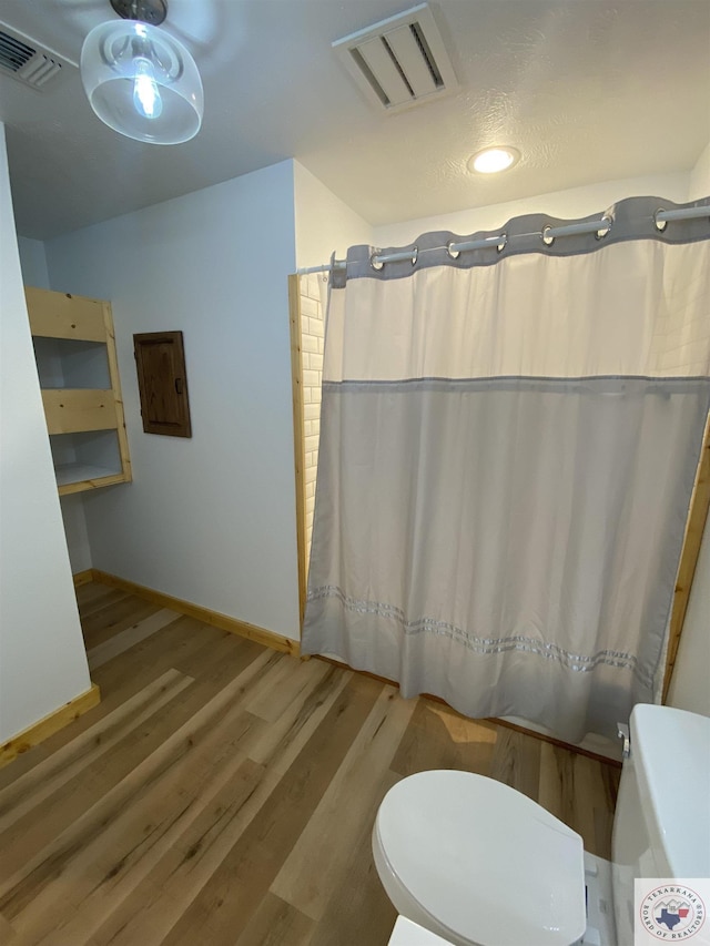 bathroom featuring toilet and hardwood / wood-style floors