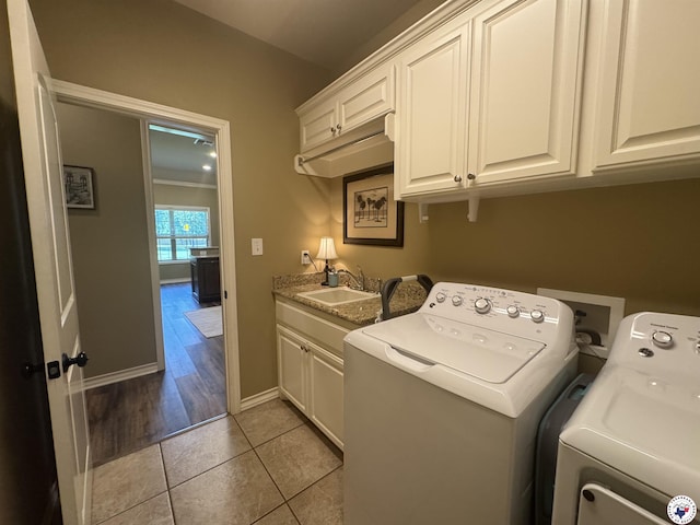 22 Heritage Blvd, Texarkana, TX 75501 - washroom with cabinet space, washer and clothes dryer, and light tile patterned floors