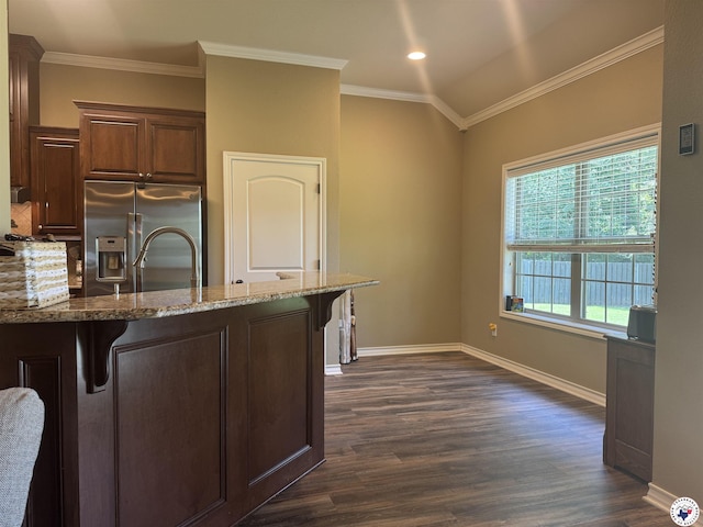 22 Heritage Blvd, Texarkana, TX 75501 - kitchen featuring stainless steel refrigerator with ice dispenser, dark wood finished floors, a kitchen bar, light stone counters, and ornamental molding