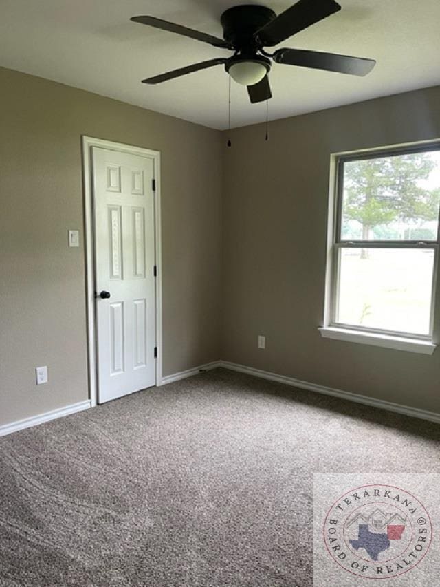 spare room with ceiling fan and carpet flooring