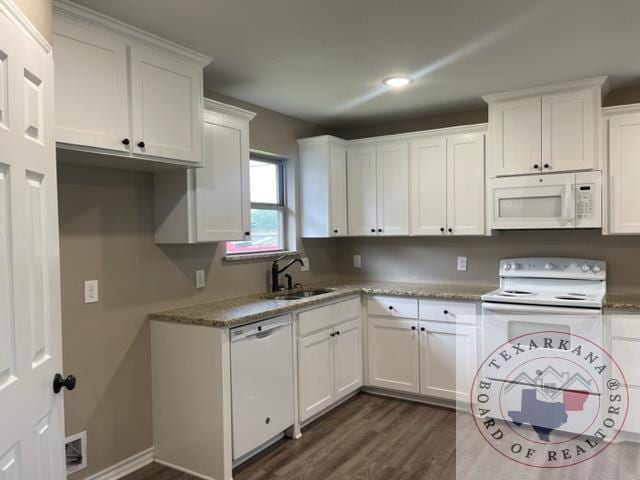 kitchen with sink, white cabinetry, white appliances, and dark wood-type flooring