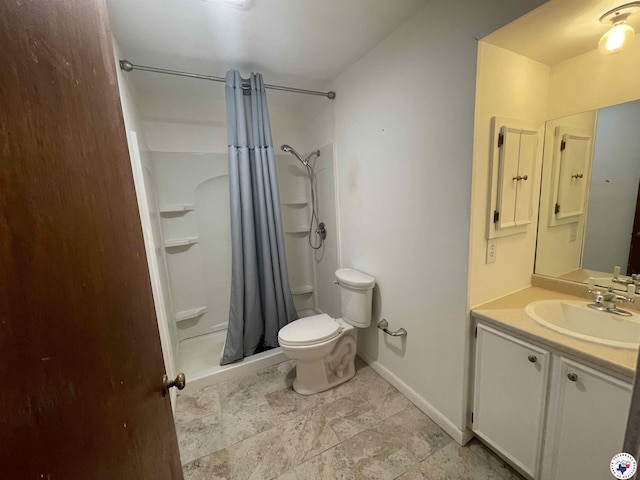 bathroom featuring vanity, toilet, baseboards, and a stall shower