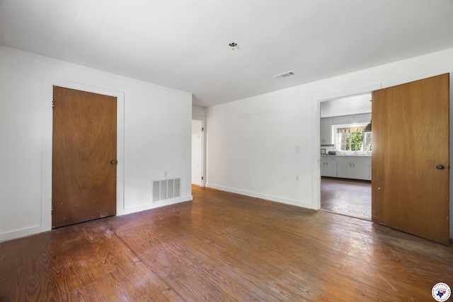 6008 E 9th St, Texarkana, AR 71854 - spare room featuring wood finished floors and a pendent fire sprinkler