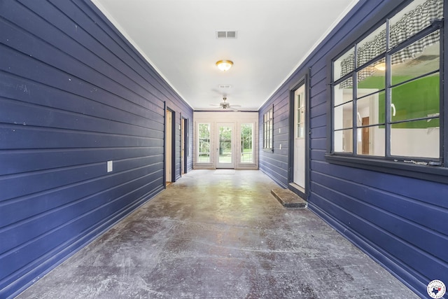6008 E 9th St, Texarkana, AR 71854 - hallway featuring crown molding, wooden walls, and concrete flooring