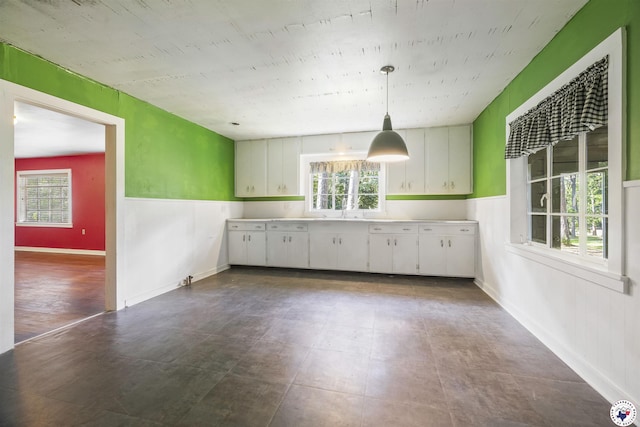 6008 E 9th St, Texarkana, AR 71854 - kitchen featuring light countertops, white cabinetry, and hanging light fixtures