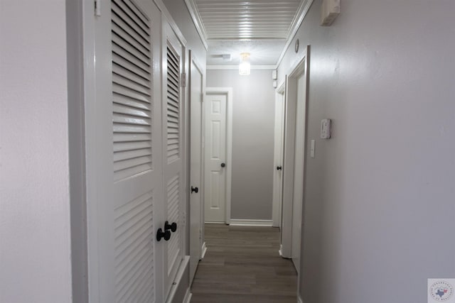 hallway with ornamental molding and dark wood-type flooring