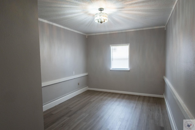 empty room with crown molding and dark hardwood / wood-style floors