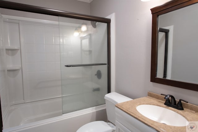 full bathroom featuring vanity, toilet, and shower / bath combination with glass door