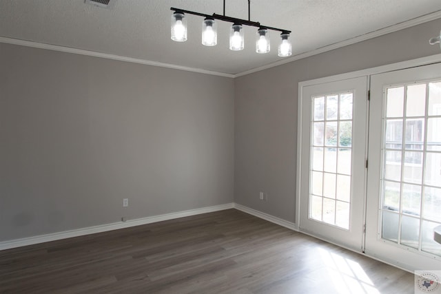 interior space with dark wood-type flooring, a textured ceiling, and ornamental molding