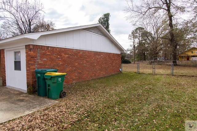 view of side of home with a lawn