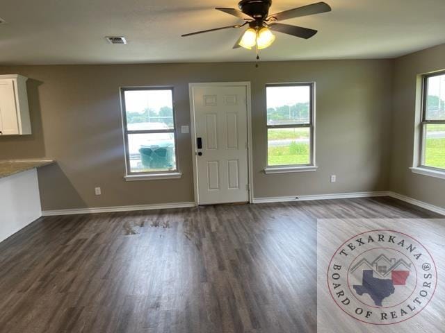 foyer featuring ceiling fan, dark hardwood / wood-style flooring, and a healthy amount of sunlight