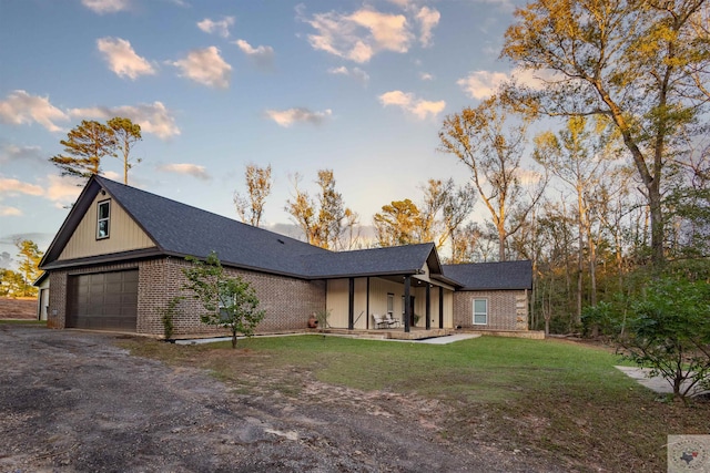 view of front of house featuring a garage and a front lawn