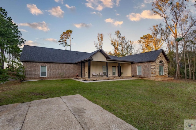 rear view of house featuring a yard