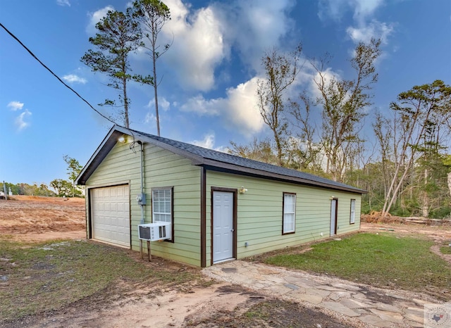 view of outdoor structure with a garage and cooling unit