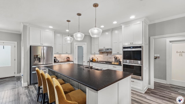 155 Lillian Ln, Texarkana, TX 75501 - kitchen featuring appliances with stainless steel finishes, dark countertops, ornamental molding, tasteful backsplash, and white cabinets