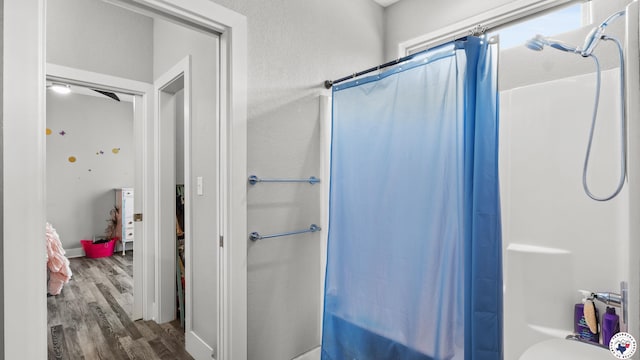 155 Lillian Ln, Texarkana, TX 75501 - full bathroom featuring wood finished floors and shower / bath combo with shower curtain