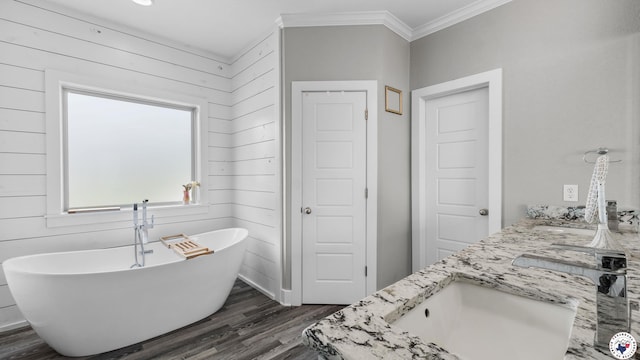 155 Lillian Ln, Texarkana, TX 75501 - bathroom featuring double vanity, a freestanding bath, wood finished floors, and ornamental molding