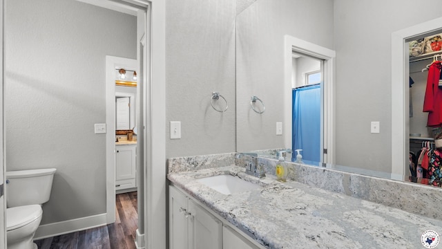 155 Lillian Ln, Texarkana, TX 75501 - bathroom with vanity, wood finished floors, and a walk in closet