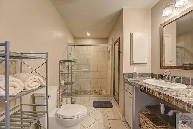 bathroom with sink, toilet, a shower with door, and tile patterned flooring