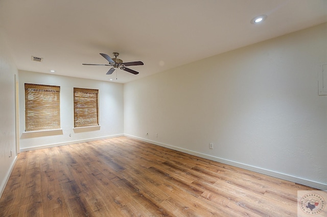 empty room featuring ceiling fan and light hardwood / wood-style floors