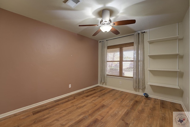 unfurnished room with ceiling fan and hardwood / wood-style floors