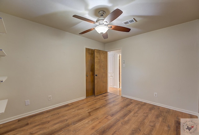 empty room with ceiling fan and wood-type flooring