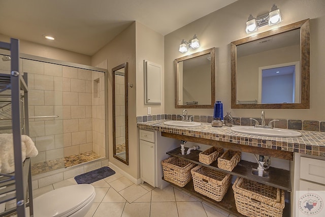 bathroom featuring vanity, toilet, tile patterned floors, and a shower with door