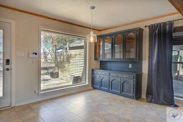 unfurnished dining area featuring crown molding