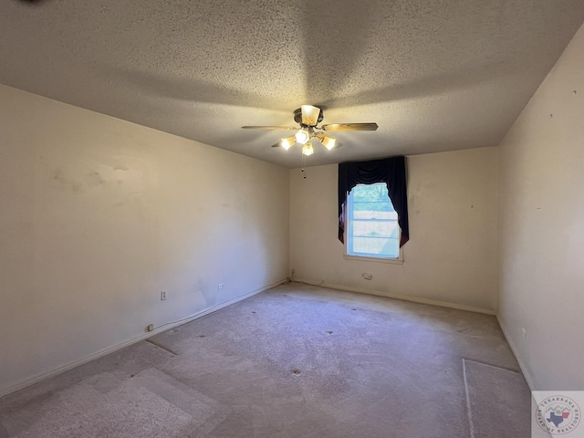 unfurnished room featuring ceiling fan, a textured ceiling, and light carpet