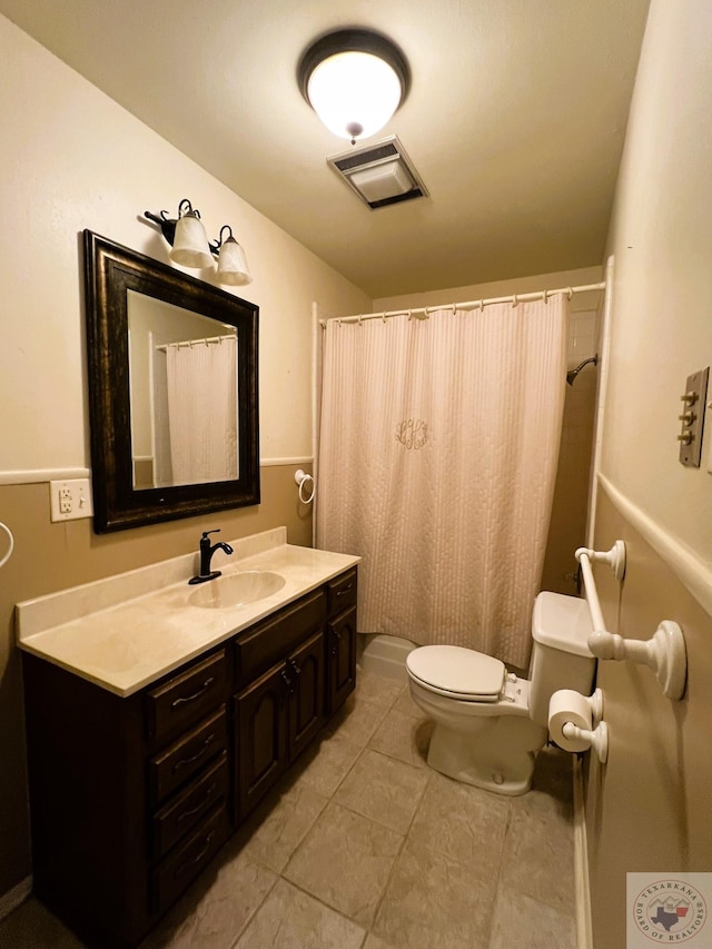 bathroom with toilet, vanity, walk in shower, and tile patterned flooring