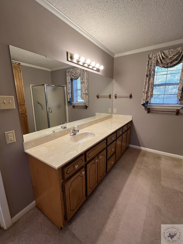 bathroom featuring crown molding, a textured ceiling, a shower with shower door, and vanity