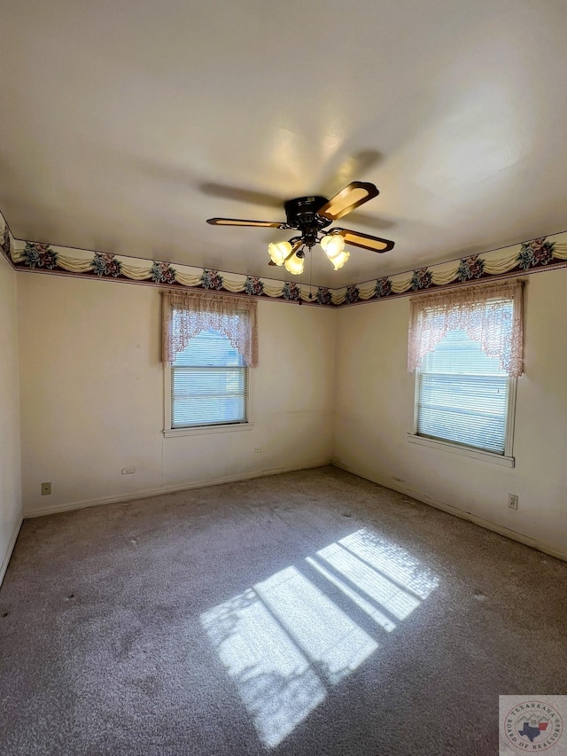 unfurnished room with ceiling fan and carpet