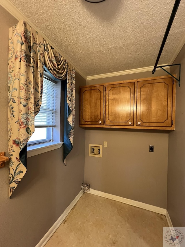 clothes washing area featuring a textured ceiling, cabinets, electric dryer hookup, washer hookup, and ornamental molding