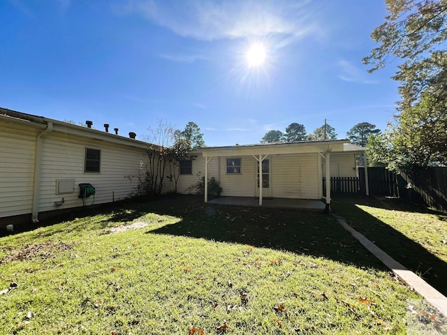 rear view of house with a yard and a patio