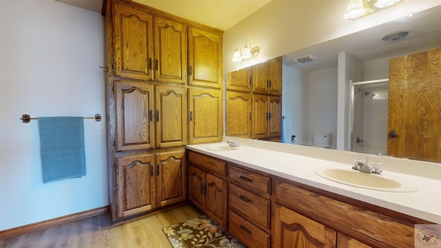 bathroom featuring hardwood / wood-style flooring, toilet, and vanity