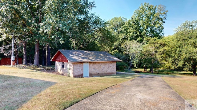 view of outbuilding featuring a lawn