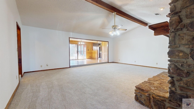 unfurnished living room with ceiling fan, carpet, a textured ceiling, and vaulted ceiling with beams