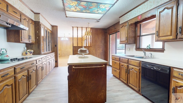 kitchen with hanging light fixtures, exhaust hood, a textured ceiling, a kitchen island, and black appliances