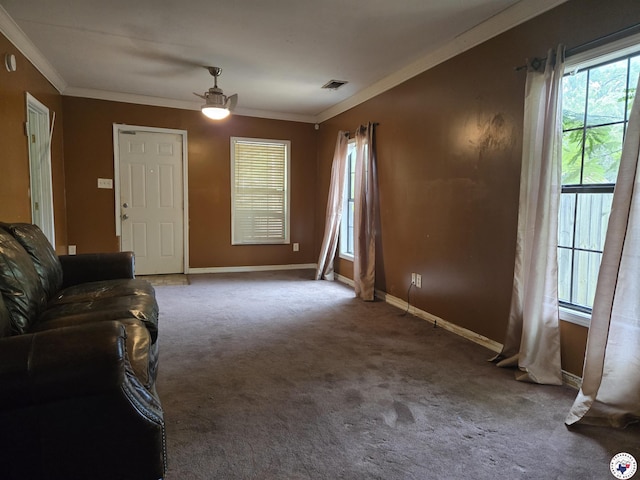 2015 W 14th St, Texarkana, TX 75501 - unfurnished living room with crown molding, ceiling fan, baseboards, and carpet flooring